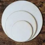 a group of circular objects on a wood surface